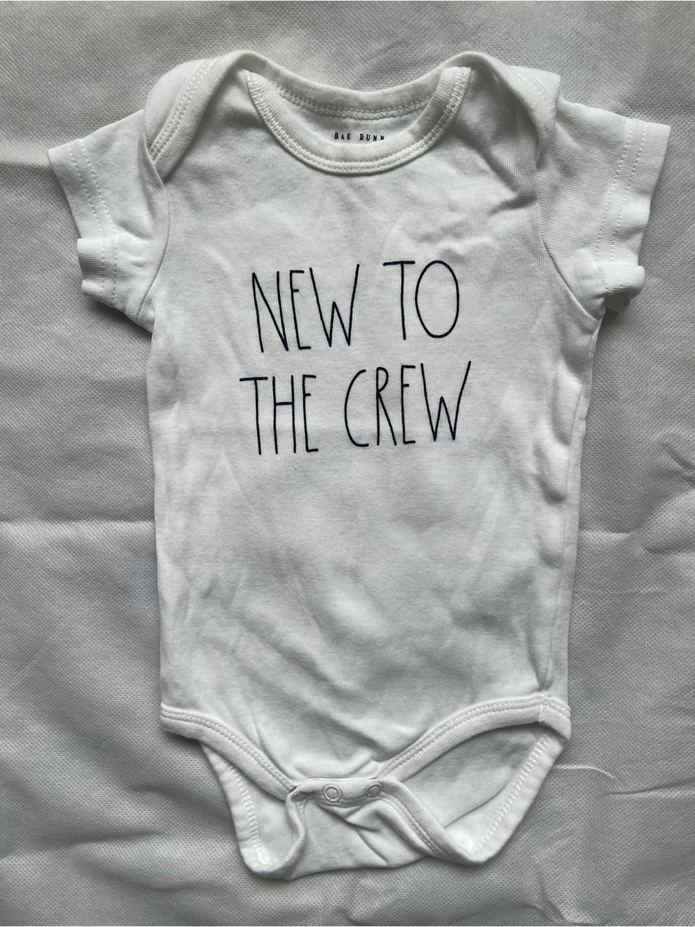 Rae Dunn White Baby Bodysuit with Black Text "New to the Crew"
